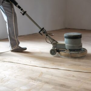 Parkettschleifmaschine im Einsatz auf einem Holzboden während der Sanierung